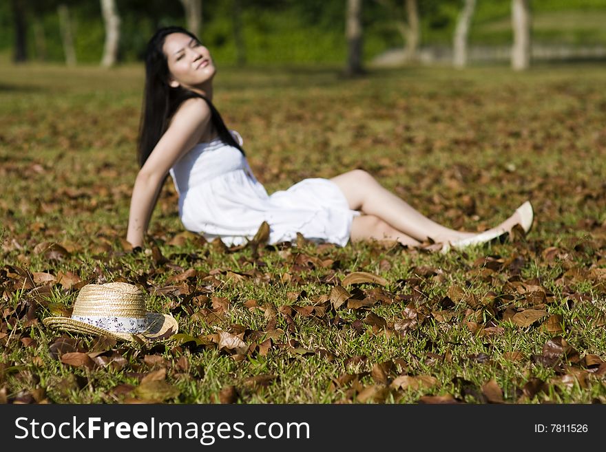 A beautiful asian girl enjoying the outdoor sun. A beautiful asian girl enjoying the outdoor sun