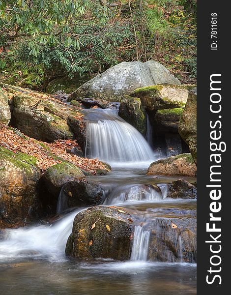 Beautiful waterfall in the middle of the forest during autumn. Beautiful waterfall in the middle of the forest during autumn.