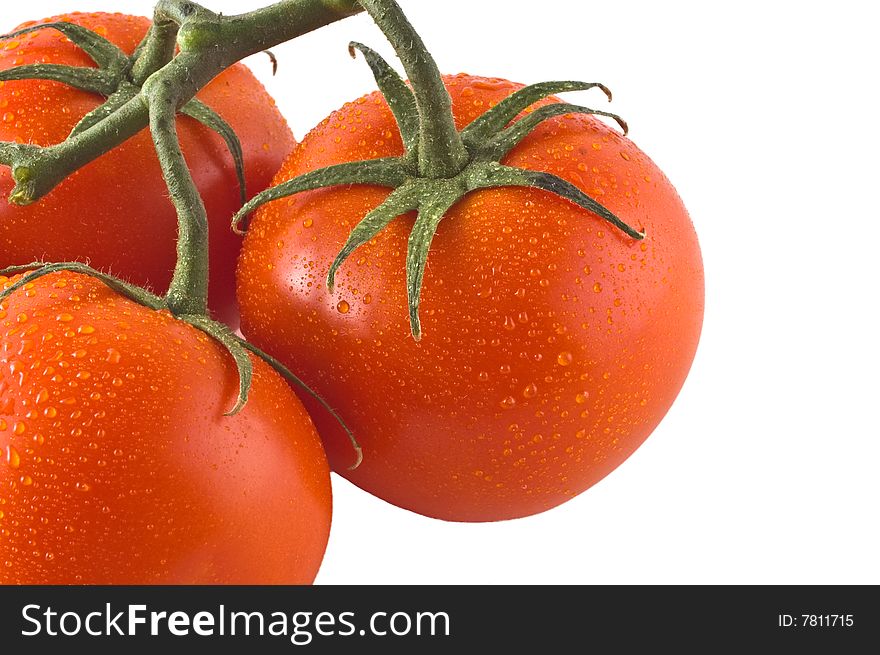 Red ripe tomatoes isolated against white, close up of one tomato with two more to the side. Red ripe tomatoes isolated against white, close up of one tomato with two more to the side.