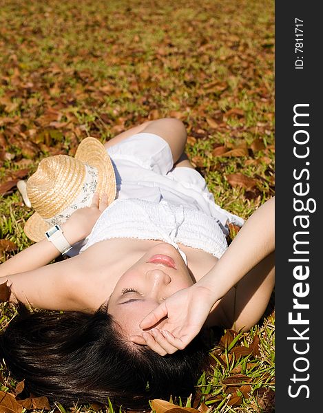 A beautiful asian girl enjoying the outdoor sun. A beautiful asian girl enjoying the outdoor sun