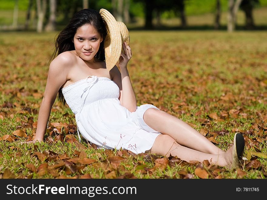 A beautiful asian girl enjoying the outdoor sun. A beautiful asian girl enjoying the outdoor sun