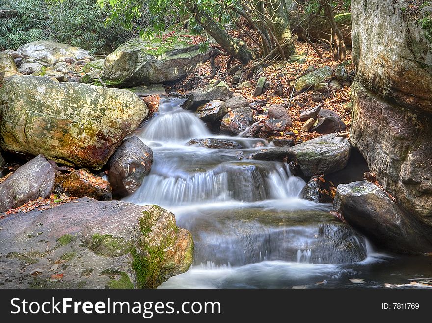 Beautiful waterfall in the middle of the forest during autumn. Beautiful waterfall in the middle of the forest during autumn.