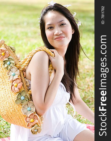 A beautiful asian girl enjoying the outdoor sun. A beautiful asian girl enjoying the outdoor sun