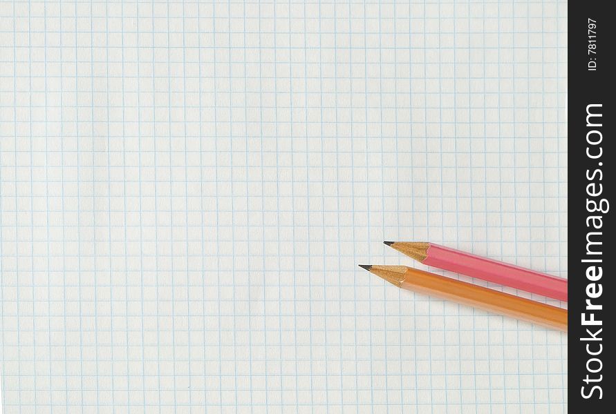 Pencils on squared sheet of a copybook. Pencils on squared sheet of a copybook