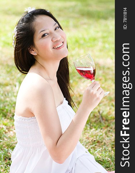 A beautiful asian girl enjoying the outdoor sun. A beautiful asian girl enjoying the outdoor sun