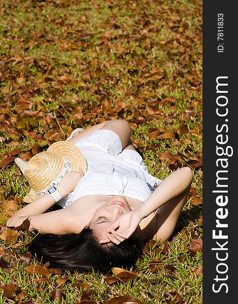 A beautiful asian girl enjoying the outdoor sun. A beautiful asian girl enjoying the outdoor sun