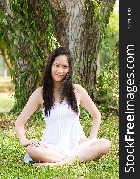 A beautiful asian girl enjoying the outdoor sun. A beautiful asian girl enjoying the outdoor sun