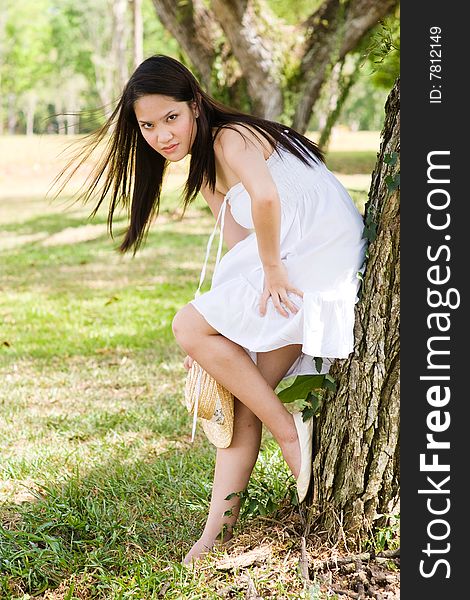 A beautiful asian girl enjoying the outdoor sun. A beautiful asian girl enjoying the outdoor sun