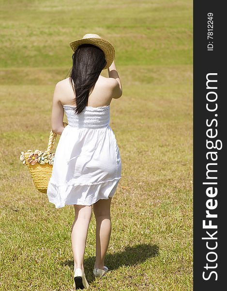 A beautiful asian girl enjoying the outdoor sun. A beautiful asian girl enjoying the outdoor sun