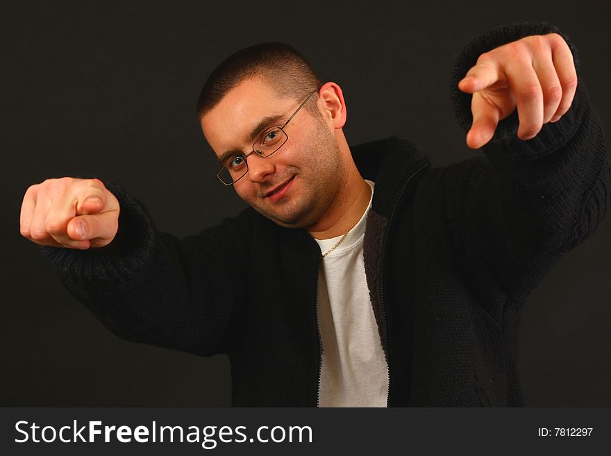 Young relaxed casual man pointing with his finger