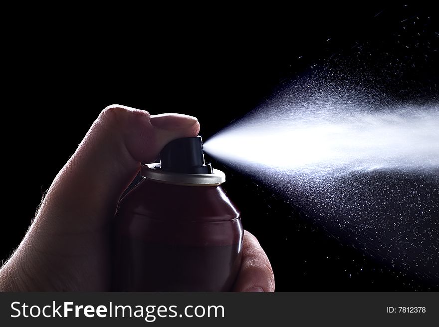 Deodorant in hand isolated on black