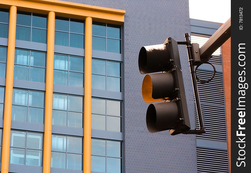 A yellow caution traffic signal light in downtown Pittsburgh