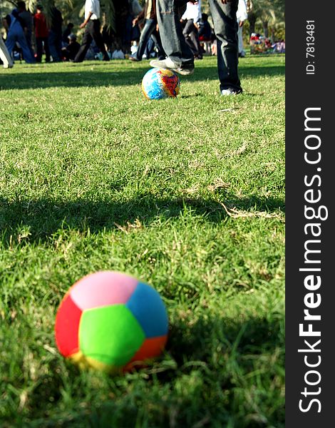 Colourful ball on the grass in a park. Colourful ball on the grass in a park