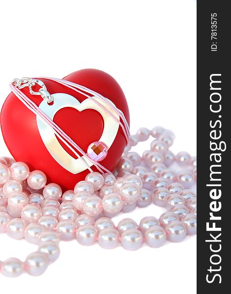 Valentine hearts and pink pearls on white background.