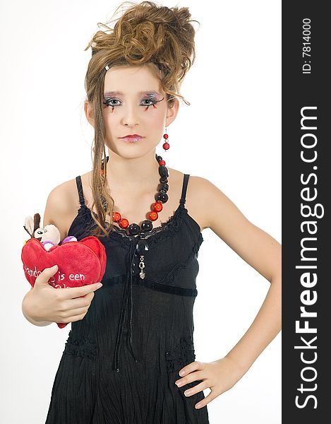 Fashion girl with black red necklace and black top holding a valentine's day present in her hand. Fashion girl with black red necklace and black top holding a valentine's day present in her hand