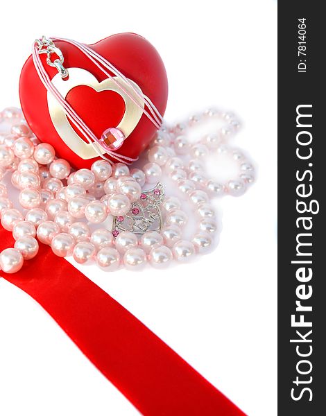 Valentine hearts,red ribbon and pink pearls on white background.