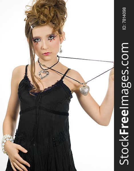 Fashion girl with black top holding a silver heart shaped necklace in her hand. Fashion girl with black top holding a silver heart shaped necklace in her hand