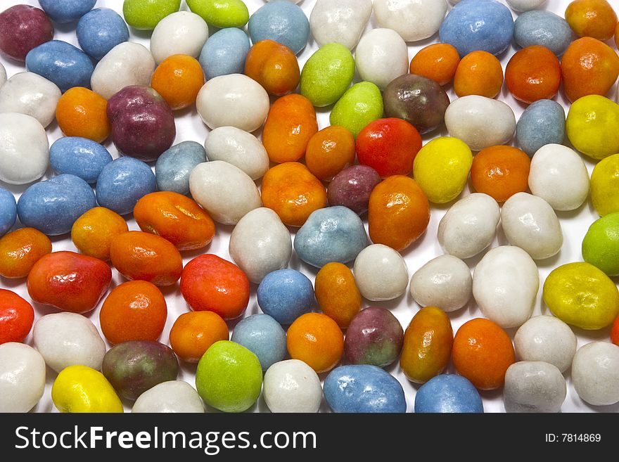 Many colored candies on white