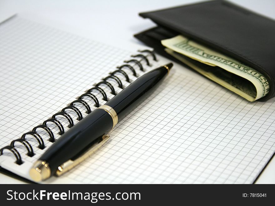 Notepad with pen and purse with money