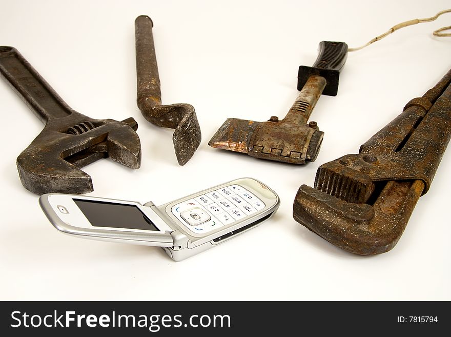 Old tools and modern telephone. Old tools and modern telephone.