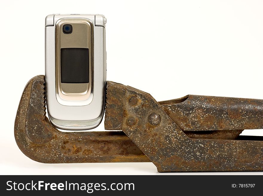 Old rusty nut key and modern telephone on a white background. Old rusty nut key and modern telephone on a white background.