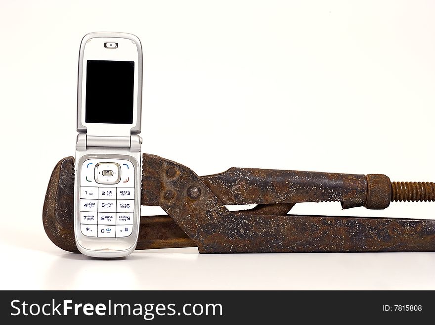 Old rusty nut key and modern telephone on a white background. Old rusty nut key and modern telephone on a white background.