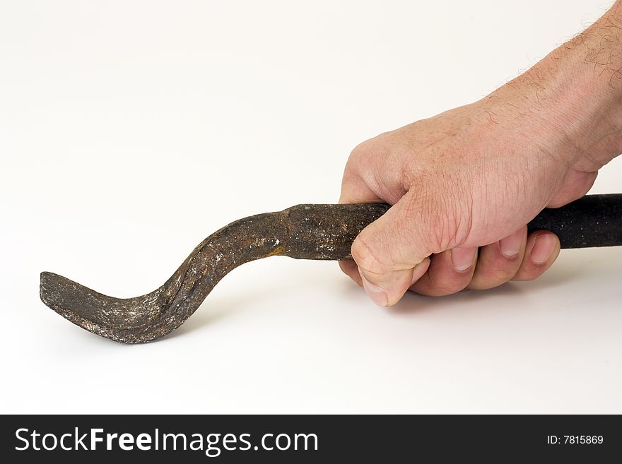 The iron tool in a hand on a white background. The iron tool in a hand on a white background.