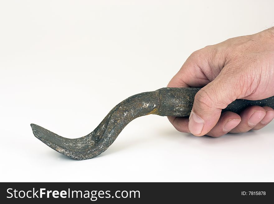 The iron tool in a hand on a white background. The iron tool in a hand on a white background.