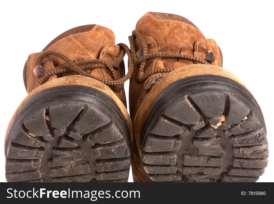 A pair of old worn walking boots isolated on a white background