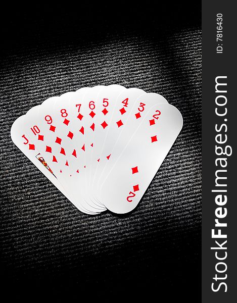 Diamond playing cards over black background.