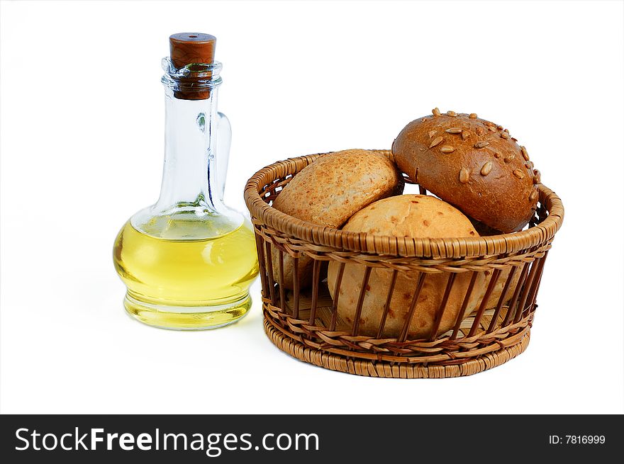 Isolated bottle oil and bread buns basket. Isolated bottle oil and bread buns basket