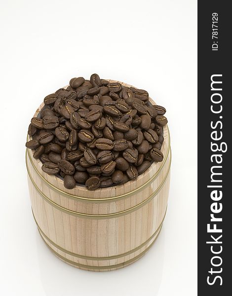 Coffee bean in oak drum on white background. Coffee bean in oak drum on white background