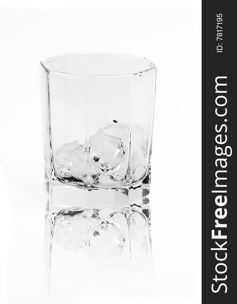 isolated on white ice in the glass with reflection. isolated on white ice in the glass with reflection
