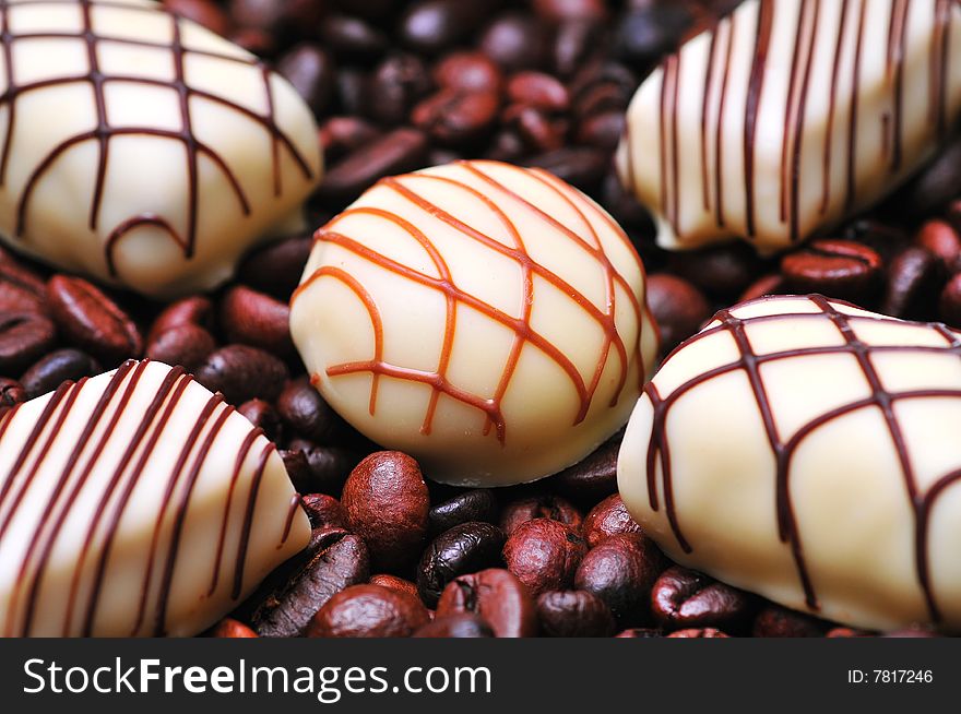 Chocolates on a stack of coffee beans background