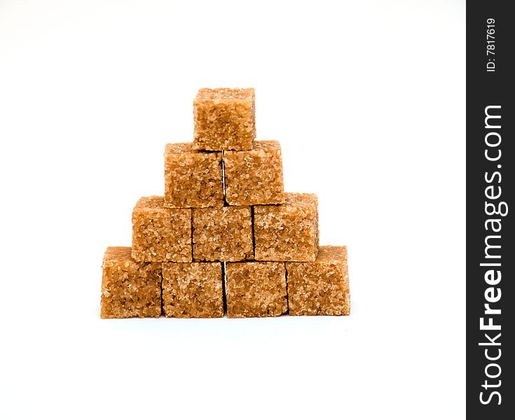 Pyramid of brown sugar cubes isolated on white background. Pyramid of brown sugar cubes isolated on white background