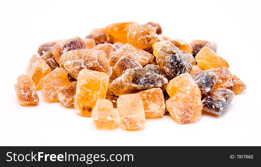 Tower of candy brown sugar isolated on white background