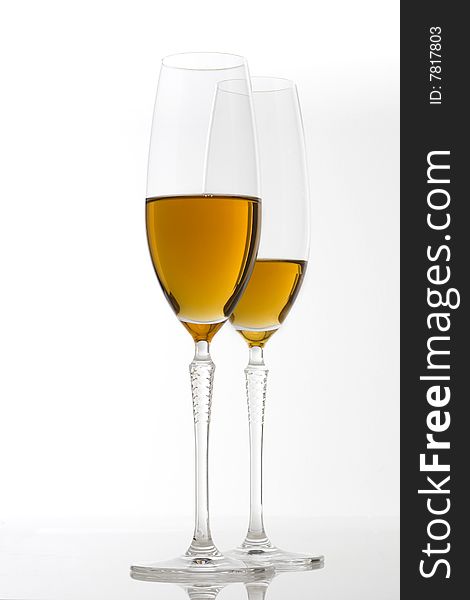 Two glasses of white wine on white background