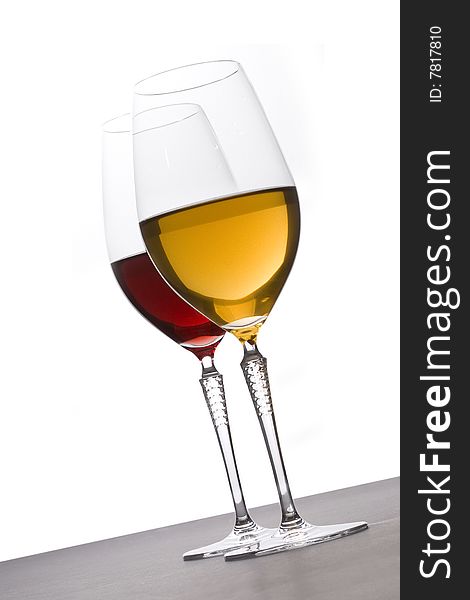 Two glasses of red and white wine on white background