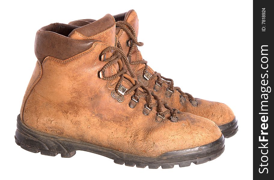 A pair of old worn walking boots isolated on a white background