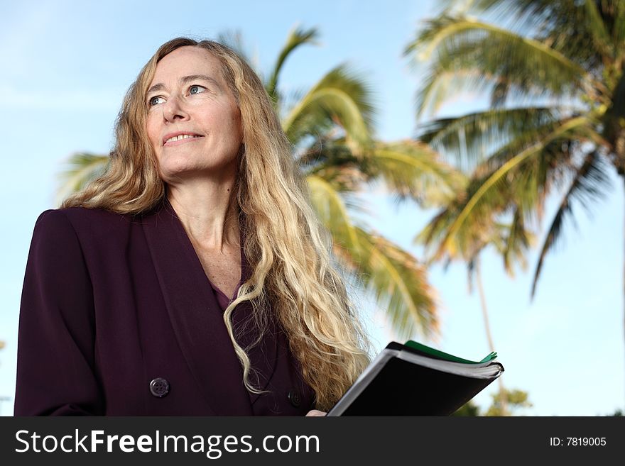 Woman smiling with palms in the background. Woman smiling with palms in the background