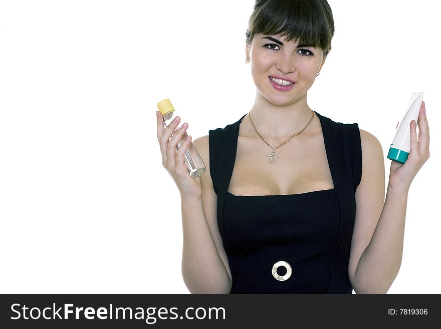 Girl with Cosmetology in hands. Isolated on white