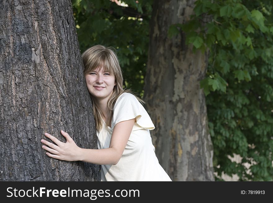 Teenager and trunk of the tree
