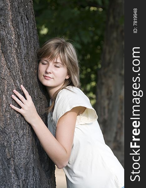 Teenager and trunk of the tree