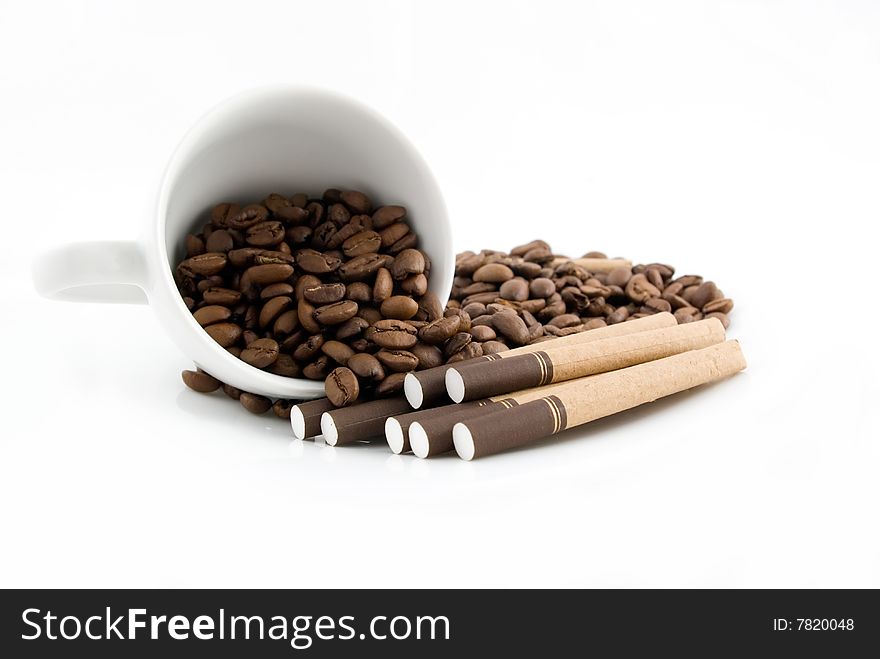 Scattered coffee and cigarettes on the white background