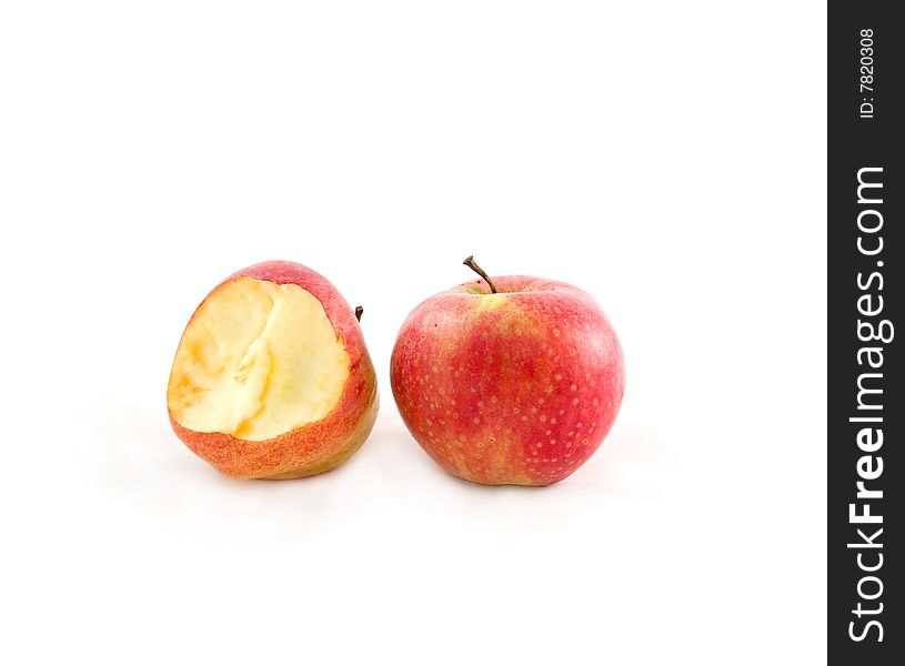 Two delightful ripe apples on the white background, one is bitten. Two delightful ripe apples on the white background, one is bitten