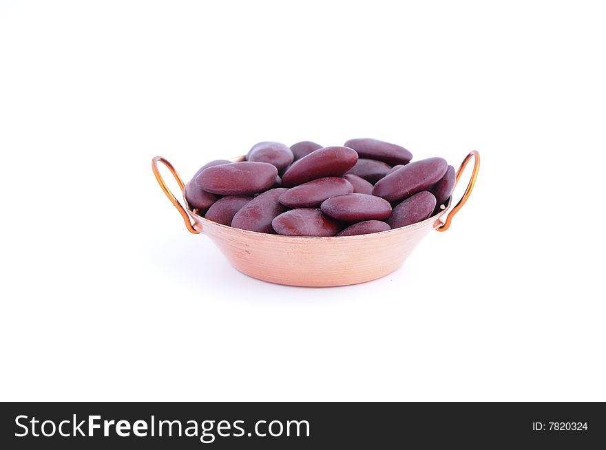 Group of raw beans in frying pan