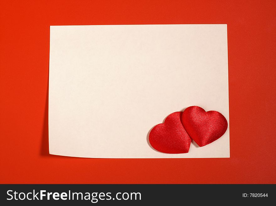 Empty sheet and two red textile hearts. Empty sheet and two red textile hearts