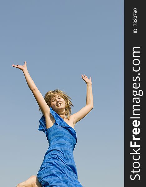 Jumping teenager on background of blue sky