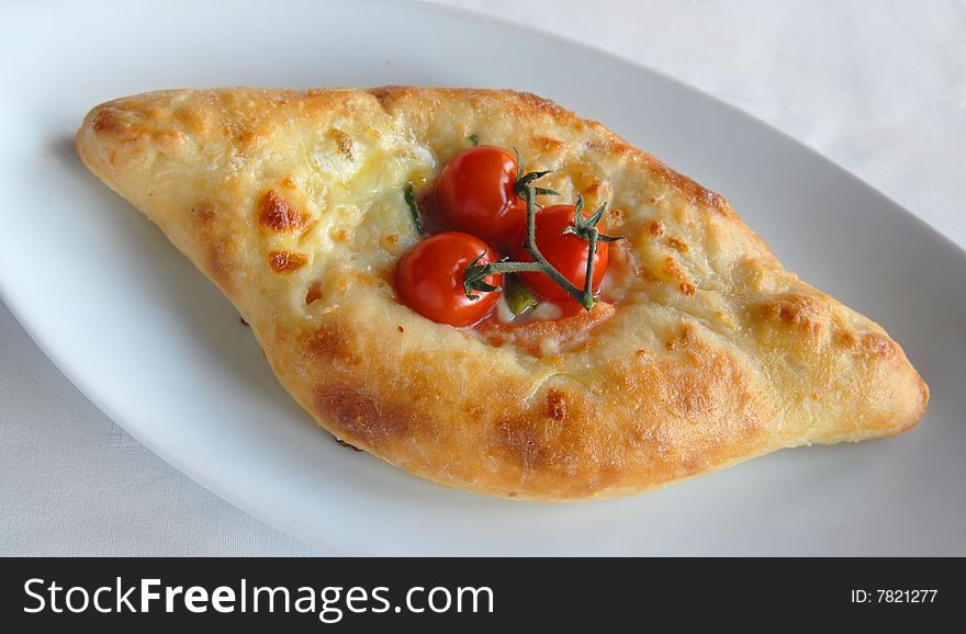 Pie with cheese and tomatoes on Georgian, khachapuri