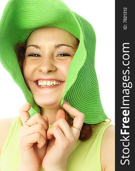 Portrait of a happy young woman with ginger hair wearing a green beach hat. Portrait of a happy young woman with ginger hair wearing a green beach hat